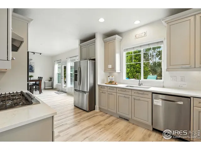 a kitchen with a refrigerator and a sink