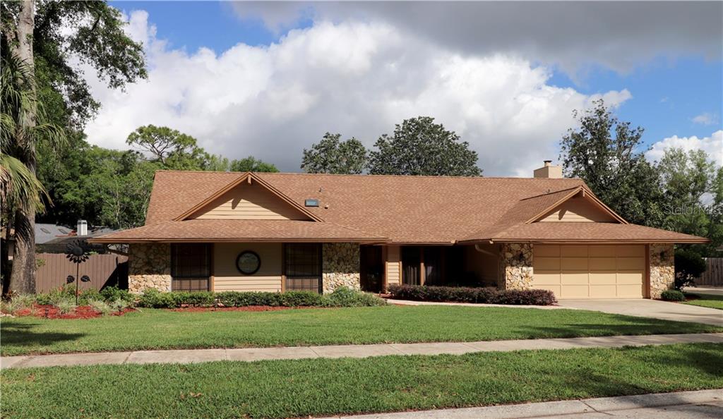 1570 North Ridge Lake Circle Longwood, FL 32750 - Photo 1 of 1 a front view of a house with a garden and trees