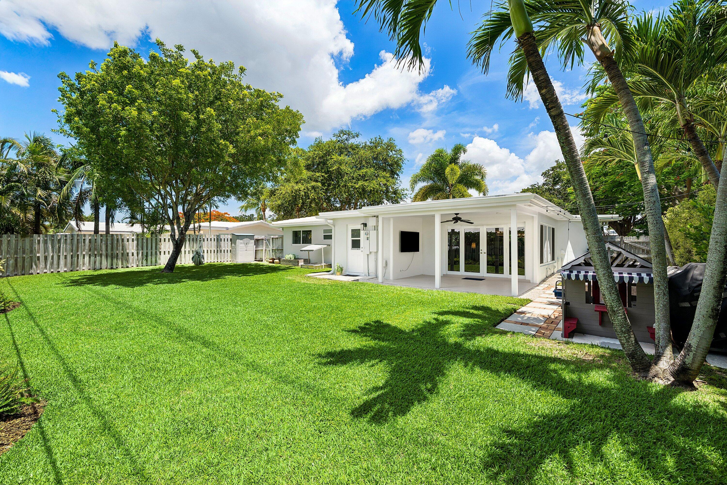 774 Southwest 7th Street Boca Raton, FL 33486 - Photo 27 of 28 a view of a house with backyard and a tree