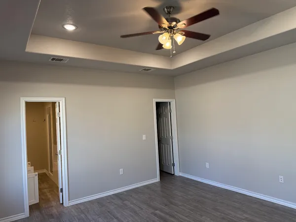 a view of an empty room with a fan
