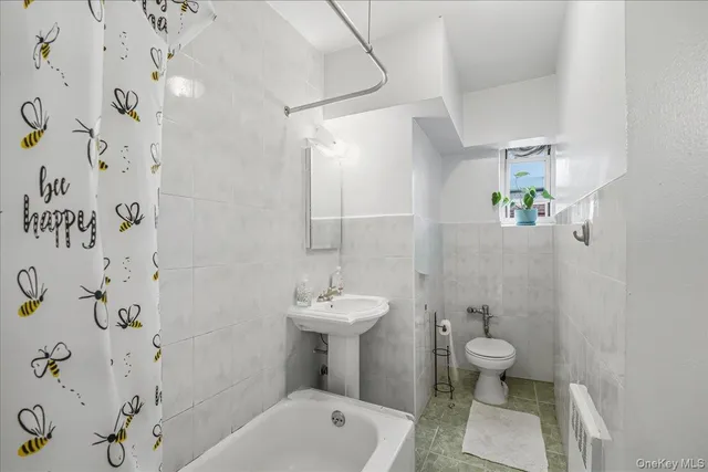 a bathroom with a sink toilet and a mirror