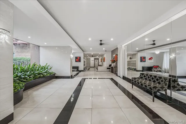 a lobby with furniture and potted plants