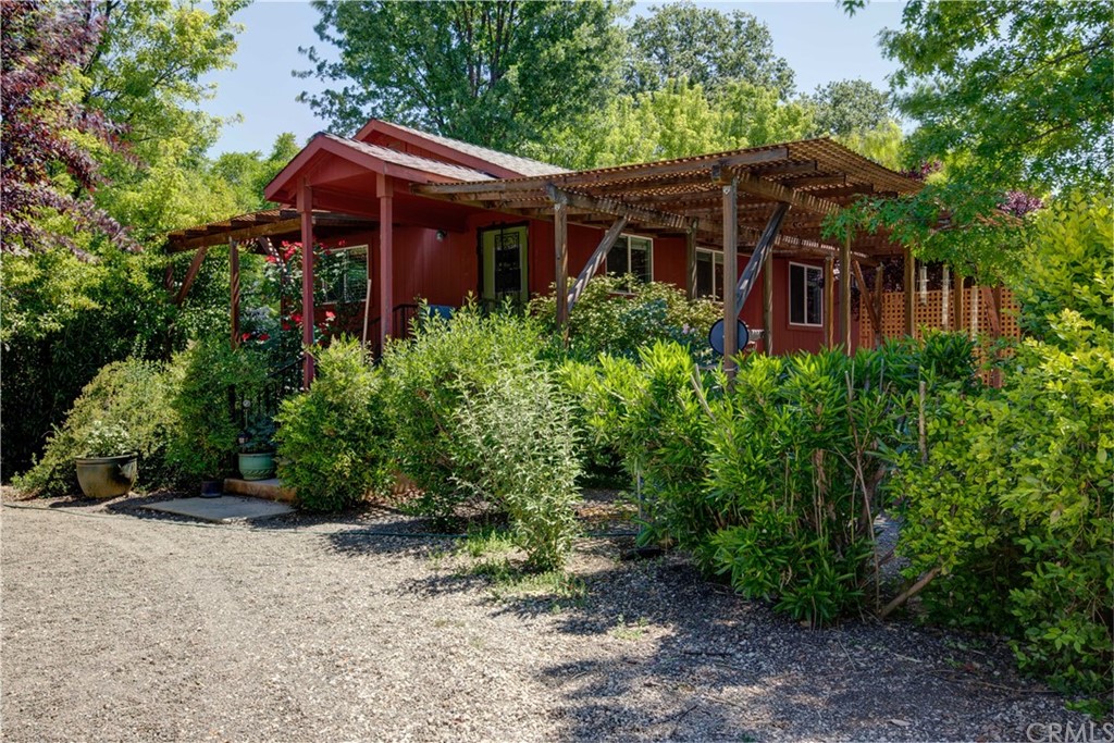 a front view of house with yard and trees