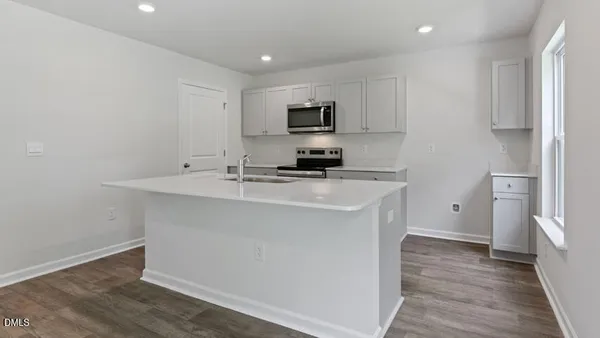 a kitchen with stainless steel appliances a sink stove and refrigerator