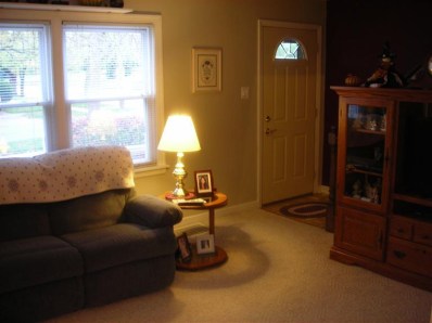 324 Beacon Place Munster, IN 46321 - Photo 7 of 10 a living room with furniture a flat screen tv and a window