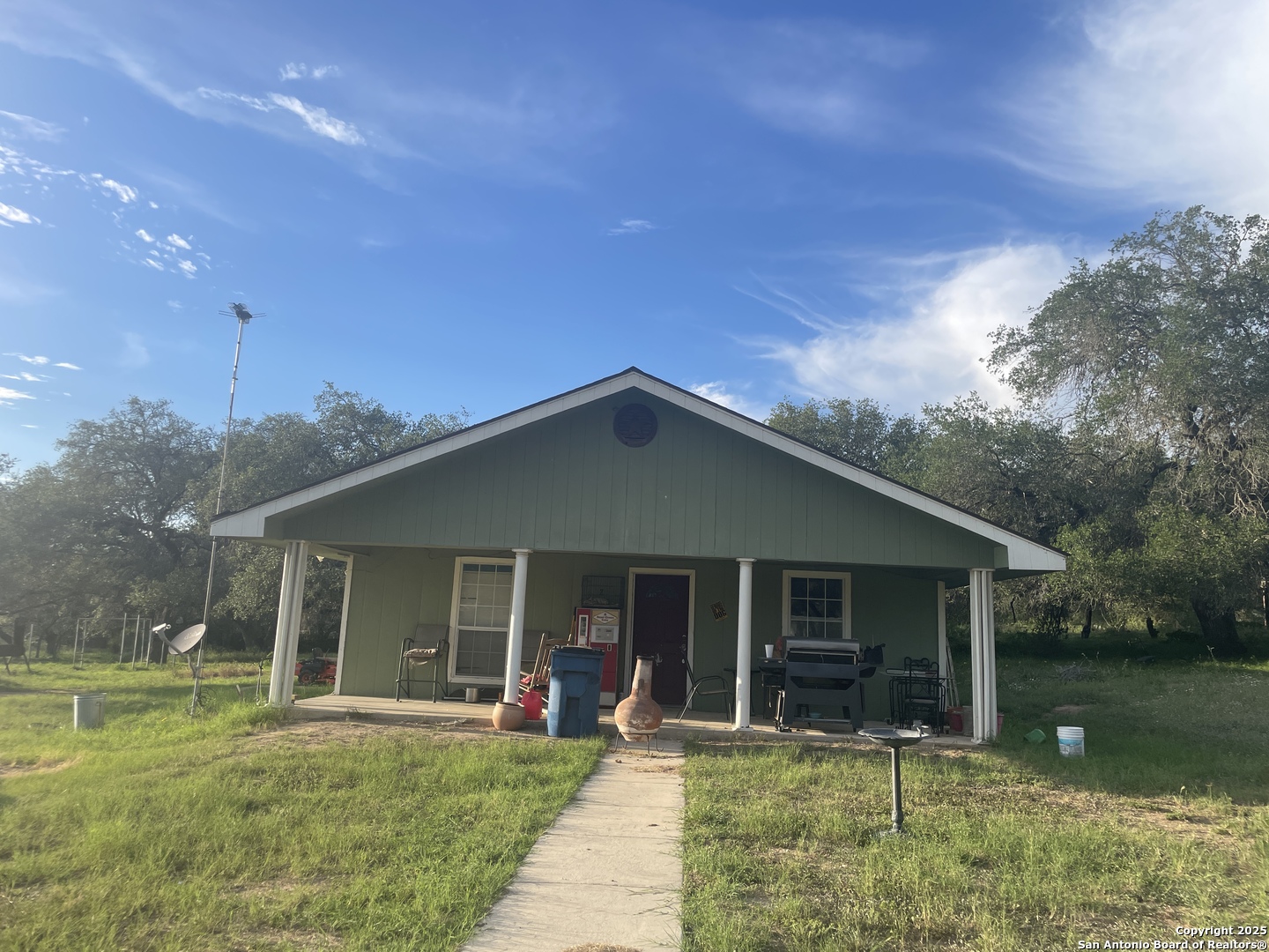 720 Ingram Road Devine, TX 78016 - Photo 1 of 1 a front view of a house with garden