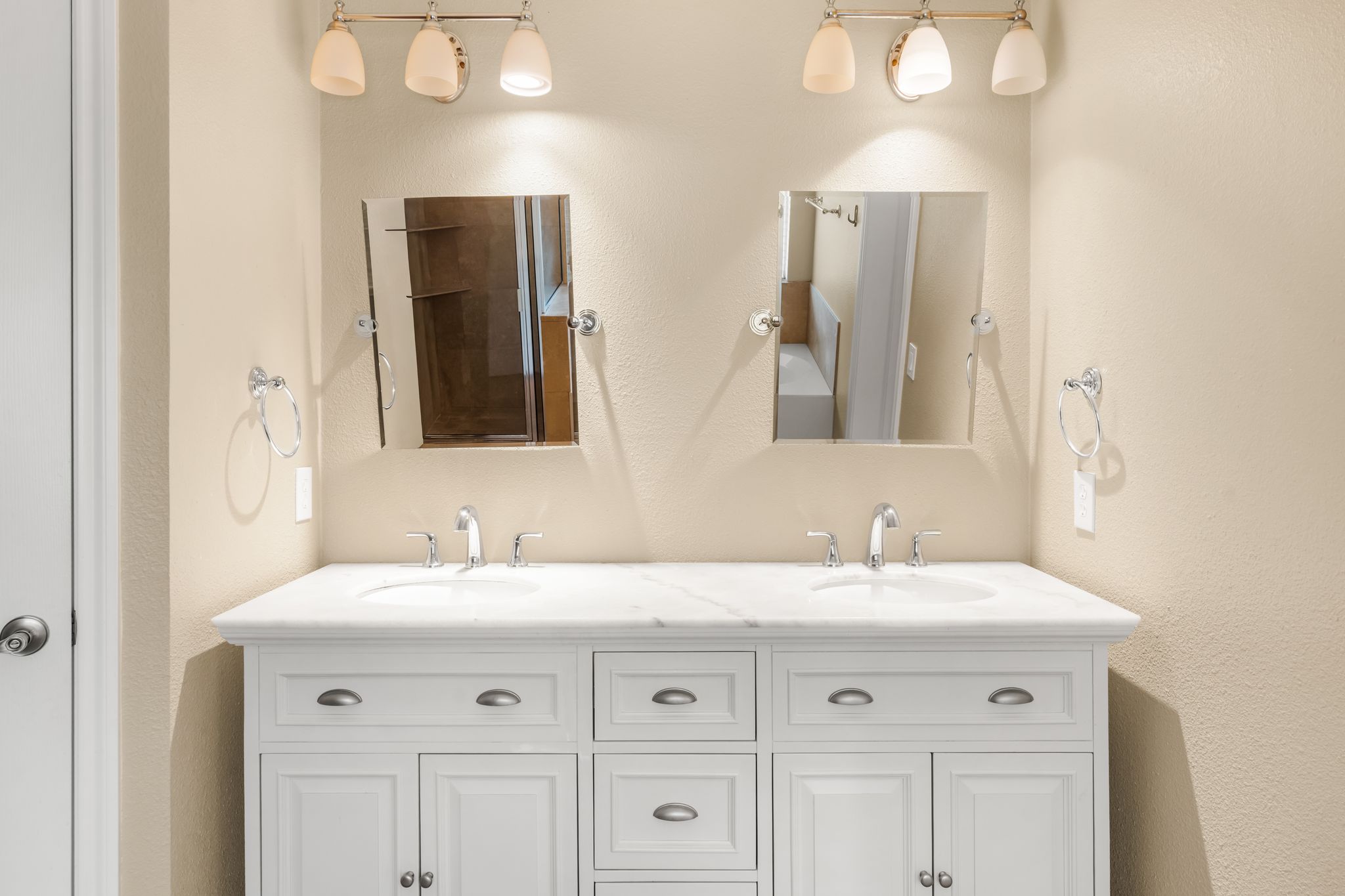3704 Caney Creek Road Austin, TX 78732 - Photo 26 of 40 Double vanity with sleek fixtures and ample storage, providing a clean and organized primary bath space.