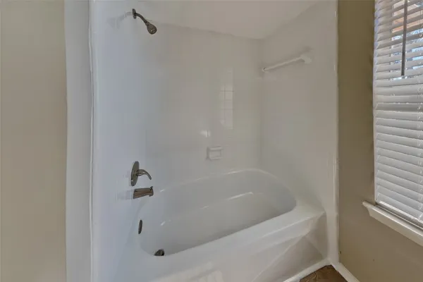 a white bath tub sitting next to a window