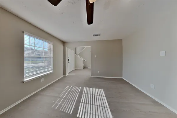 a view of an empty room with windows