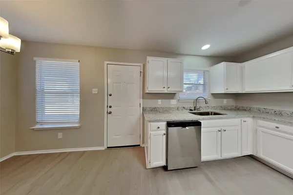 a kitchen with a sink stove and cabinets
