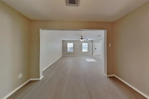 wooden floor in an empty room and a window