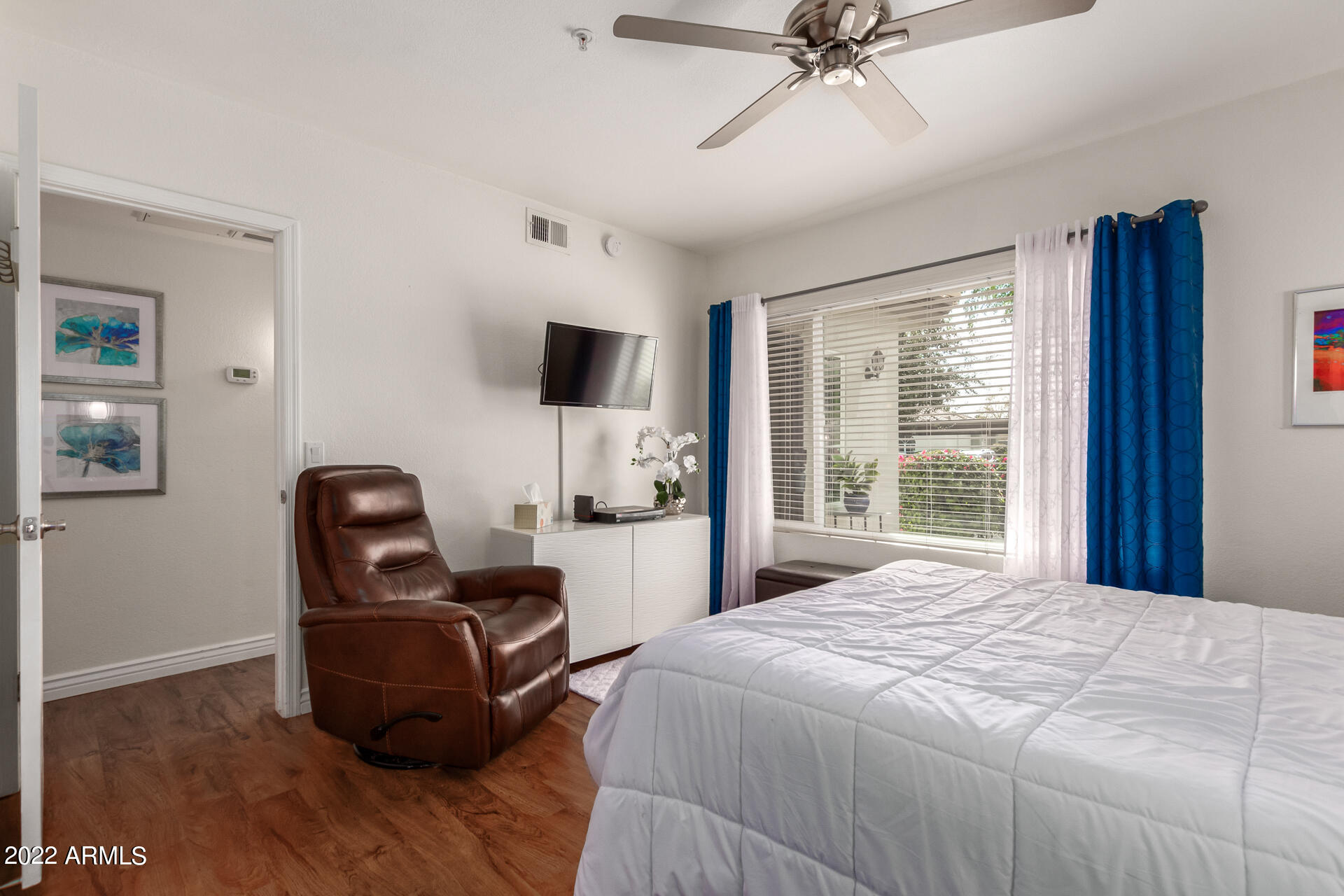 1825 West Ray Road, Unit 1049 Chandler, AZ 85224 - Photo 12 of 28 a bedroom with a bed and a chair