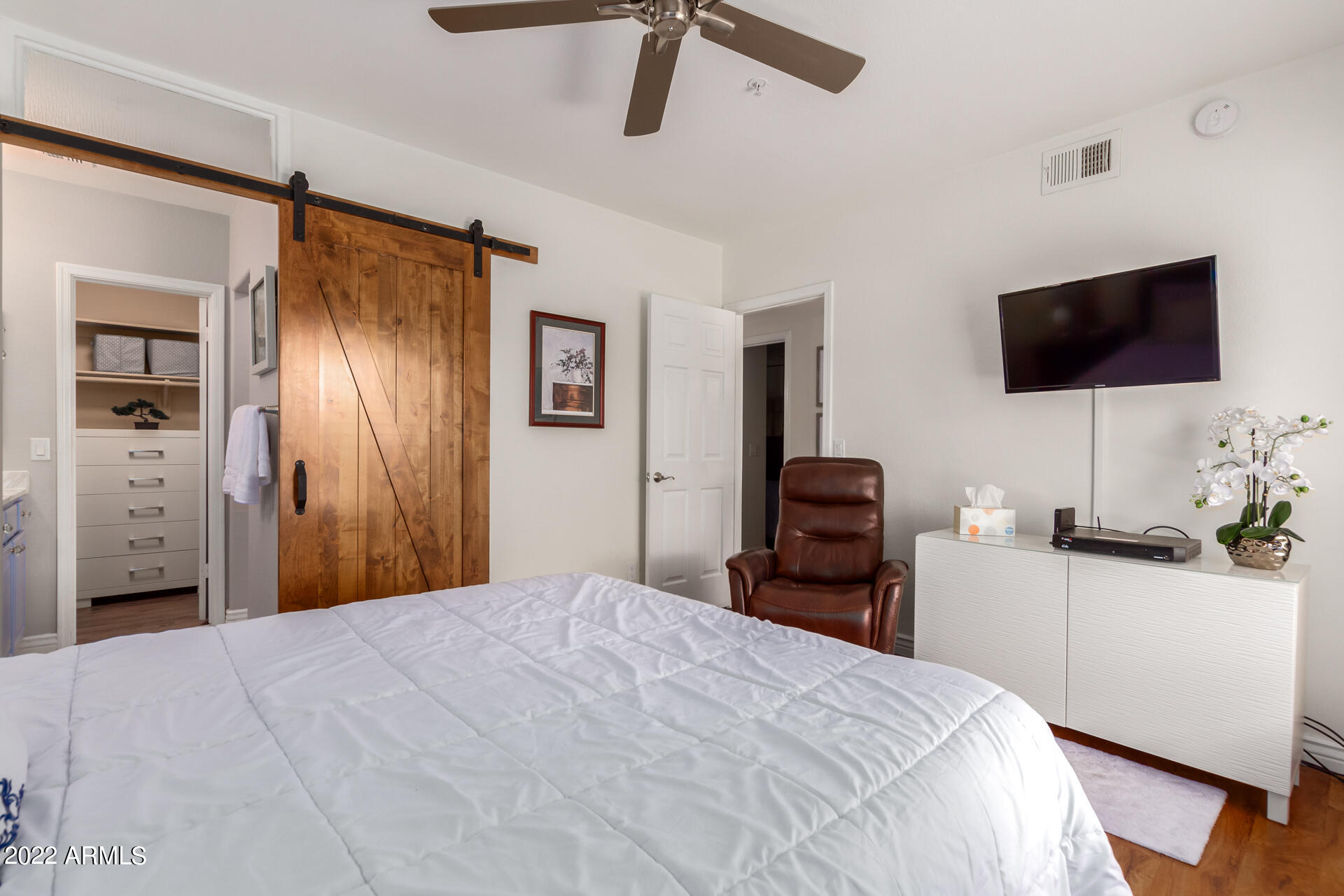 1825 West Ray Road, Unit 1049 Chandler, AZ 85224 - Photo 13 of 28 a bedroom with a bed and a flat screen tv