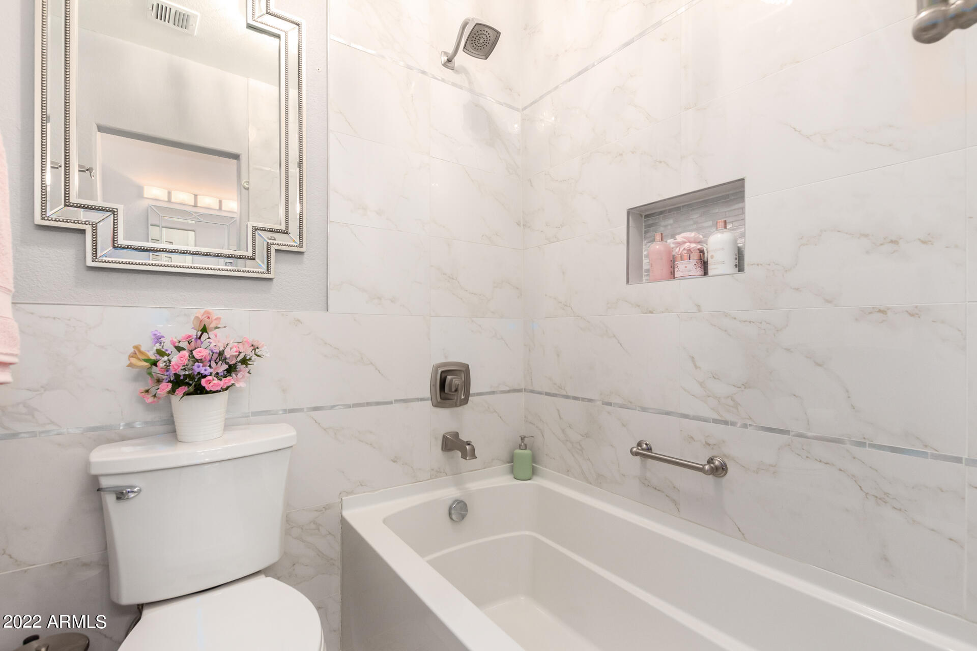 1825 West Ray Road, Unit 1049 Chandler, AZ 85224 - Photo 16 of 28 a bathroom with a toilet sink and mirror