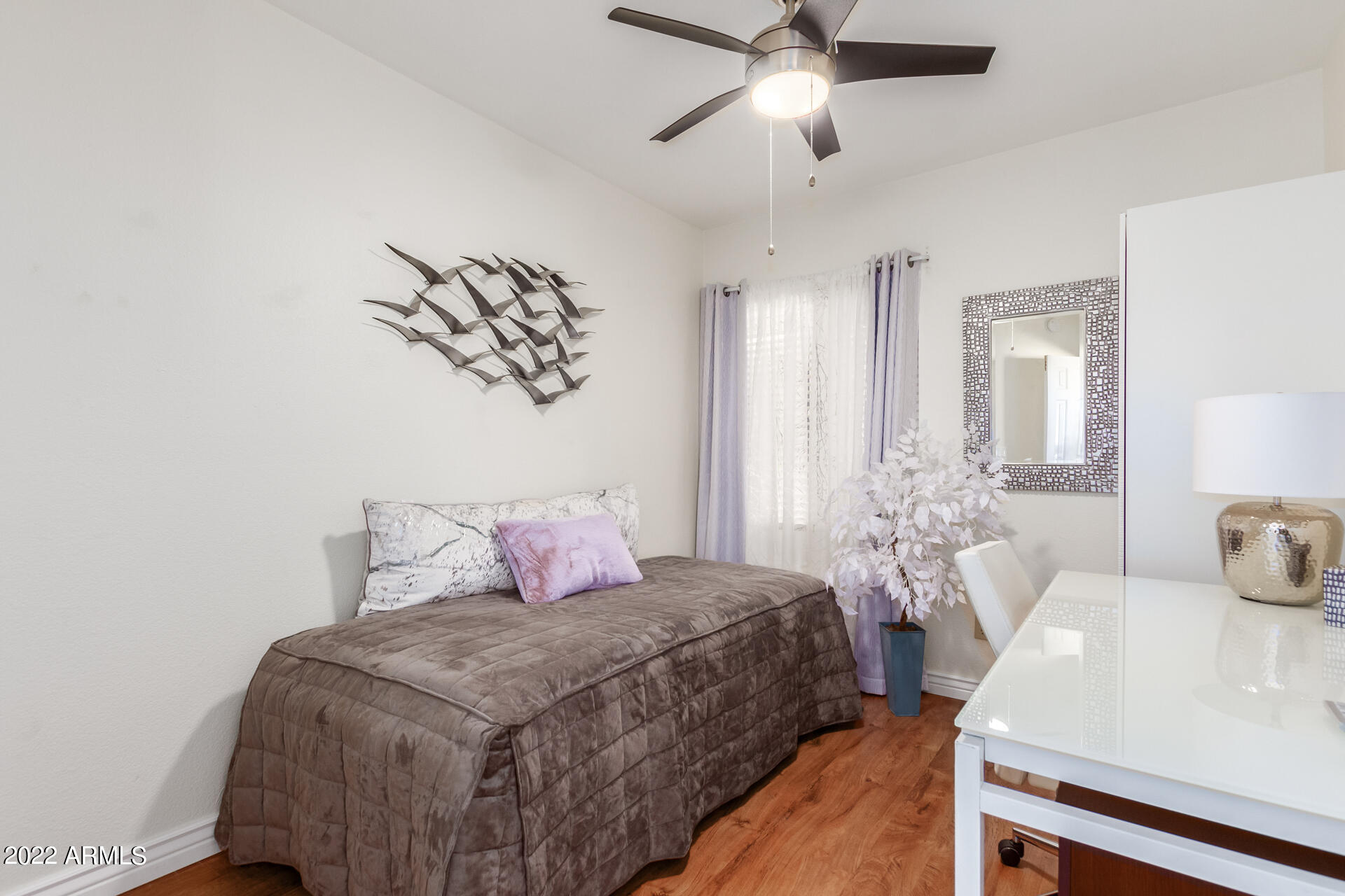 1825 West Ray Road, Unit 1049 Chandler, AZ 85224 - Photo 18 of 28 a bedroom with a bed and a chandelier
