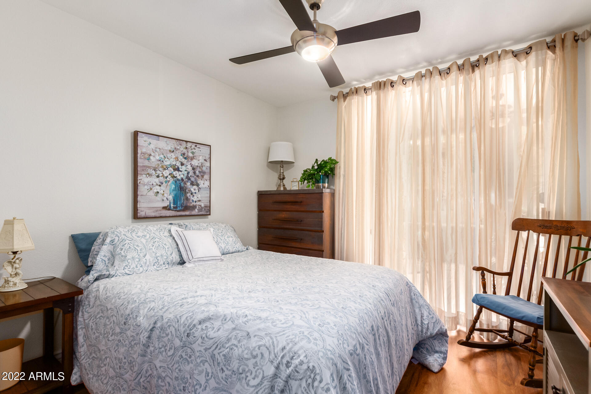 1825 West Ray Road, Unit 1049 Chandler, AZ 85224 - Photo 19 of 28 a bedroom with a bed and a chair