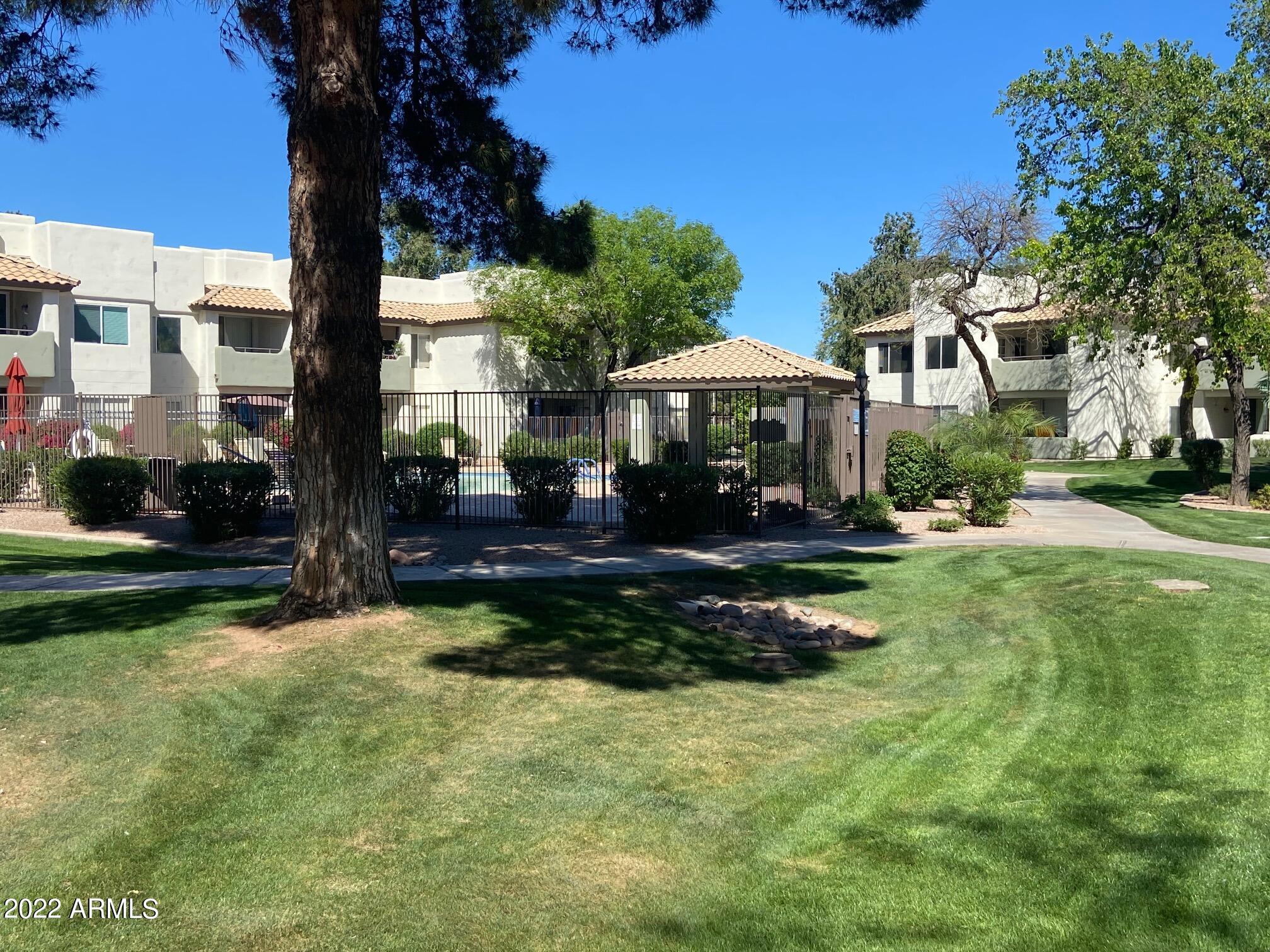 1825 West Ray Road, Unit 1049 Chandler, AZ 85224 - Photo 27 of 28 a view of a house with a yard