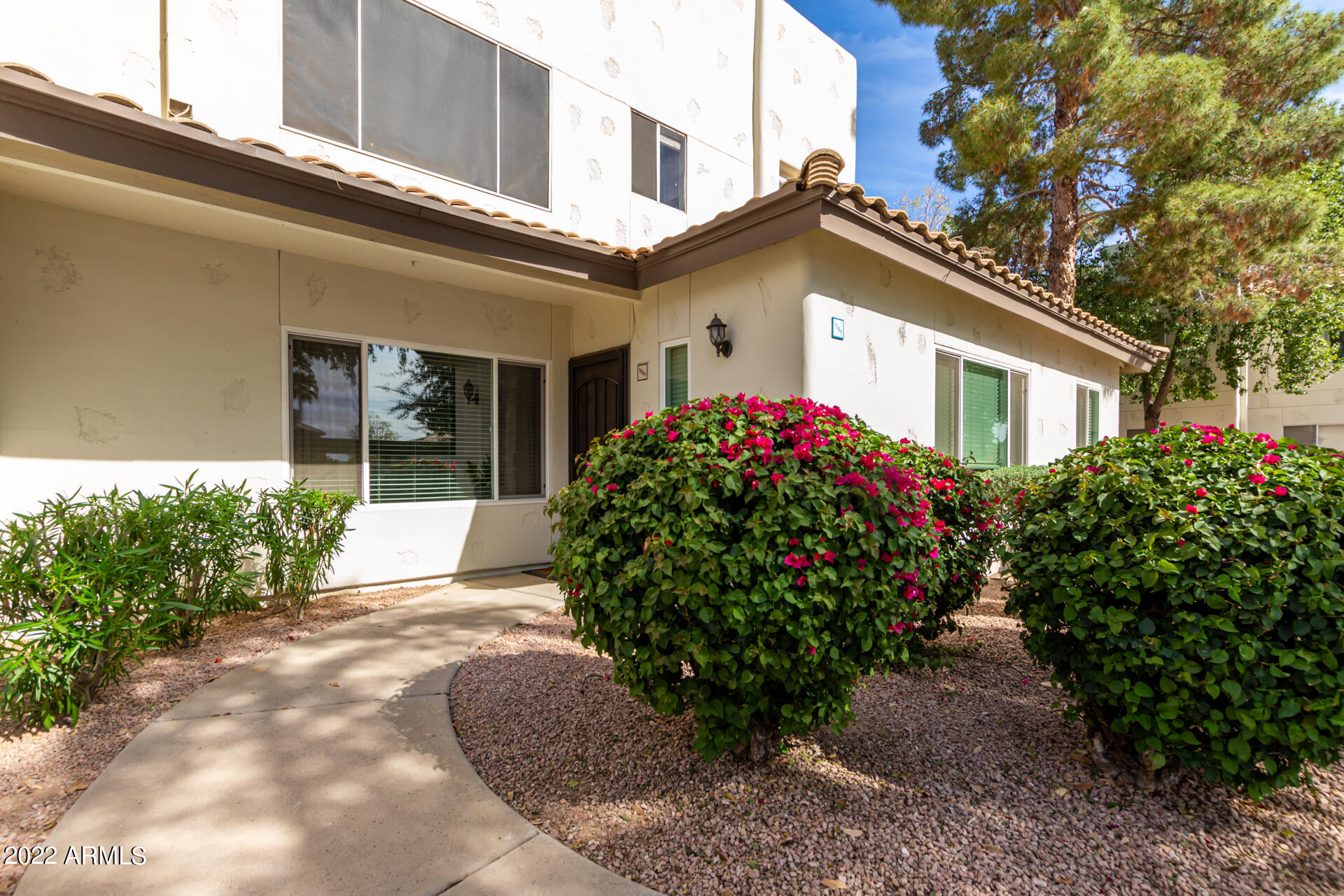 1825 West Ray Road, Unit 1049 Chandler, AZ 85224 - Photo 3 of 28 a view of a house with potted plants