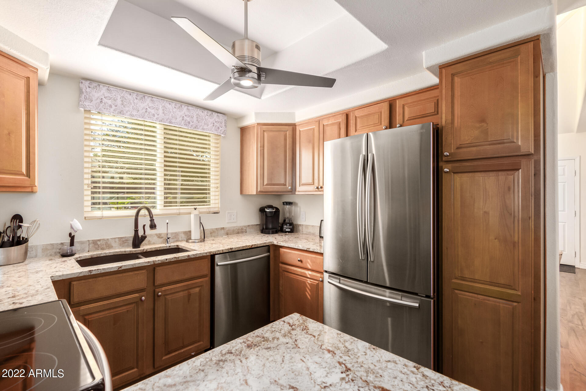 1825 West Ray Road, Unit 1049 Chandler, AZ 85224 - Photo 8 of 28 a kitchen with a refrigerator a sink and cabinets