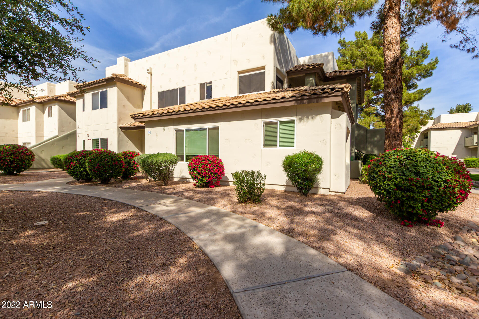 1825 West Ray Road, Unit 1049 Chandler, AZ 85224 - Photo 10 of 28 a view of a white house next to a road