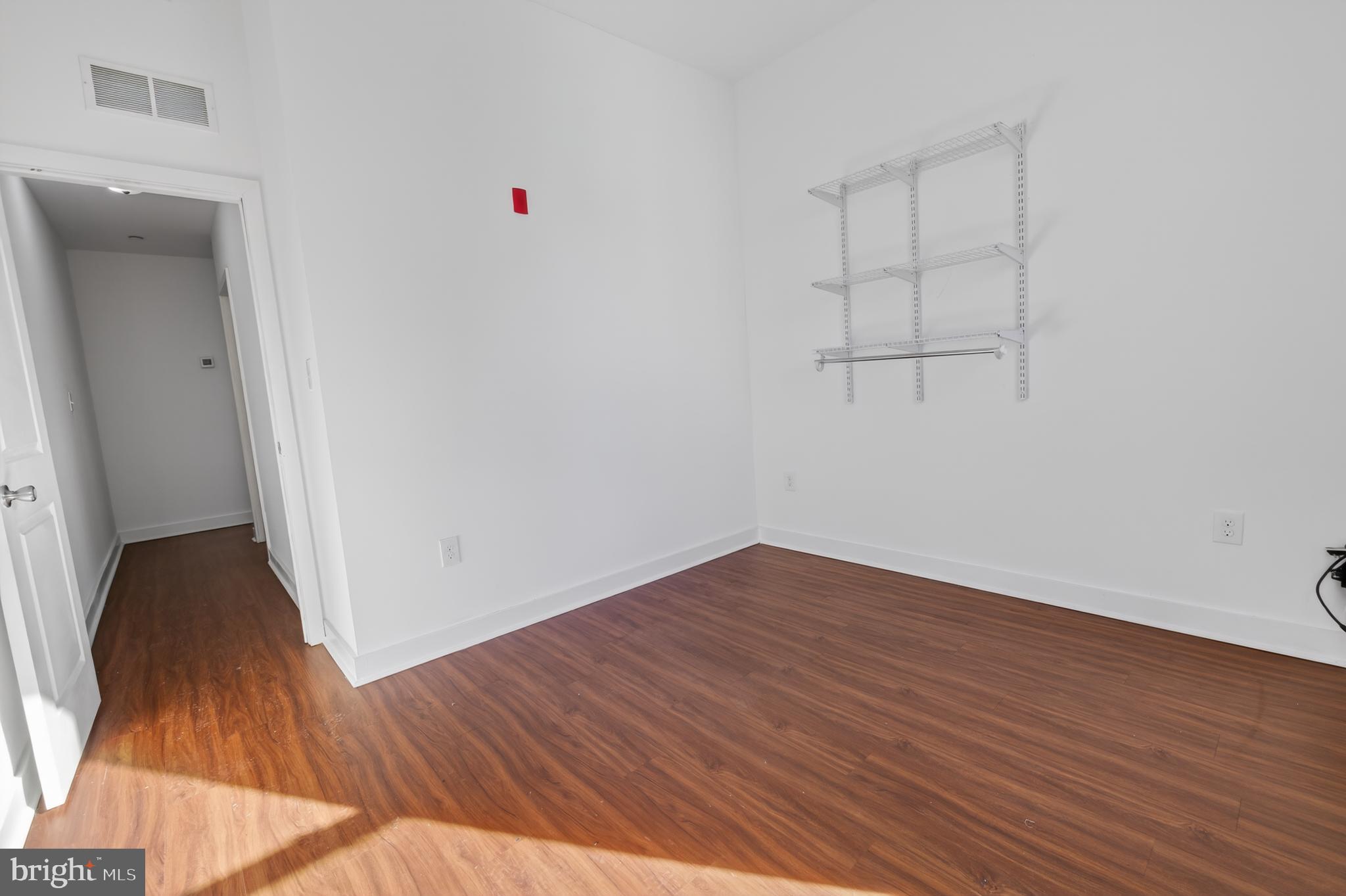 6040 Market Street, Unit 2 Philadelphia, PA 19139 - Photo 15 of 16 an empty room with wooden floor and closet