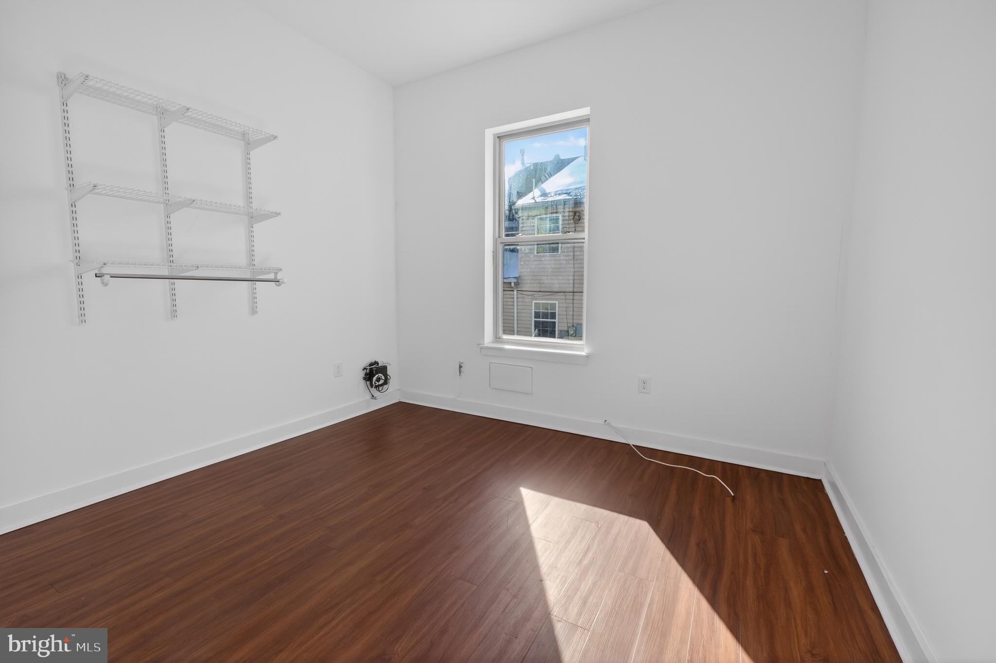 6040 Market Street, Unit 2 Philadelphia, PA 19139 - Photo 16 of 16 an empty room with wooden floor and windows