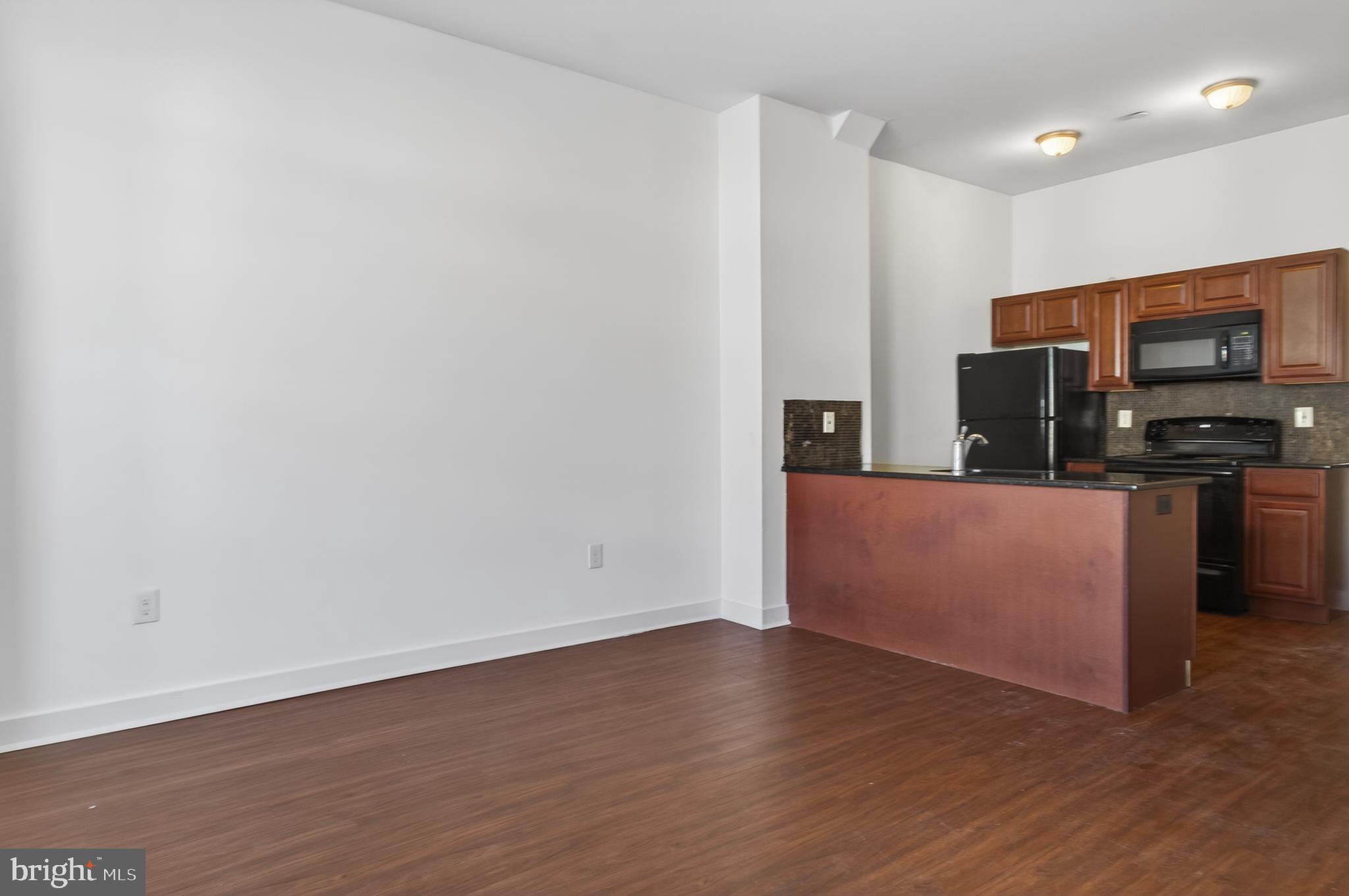 6040 Market Street, Unit 2 Philadelphia, PA 19139 - Photo 3 of 16 a view of kitchen with stainless steel appliances wooden floor and large window