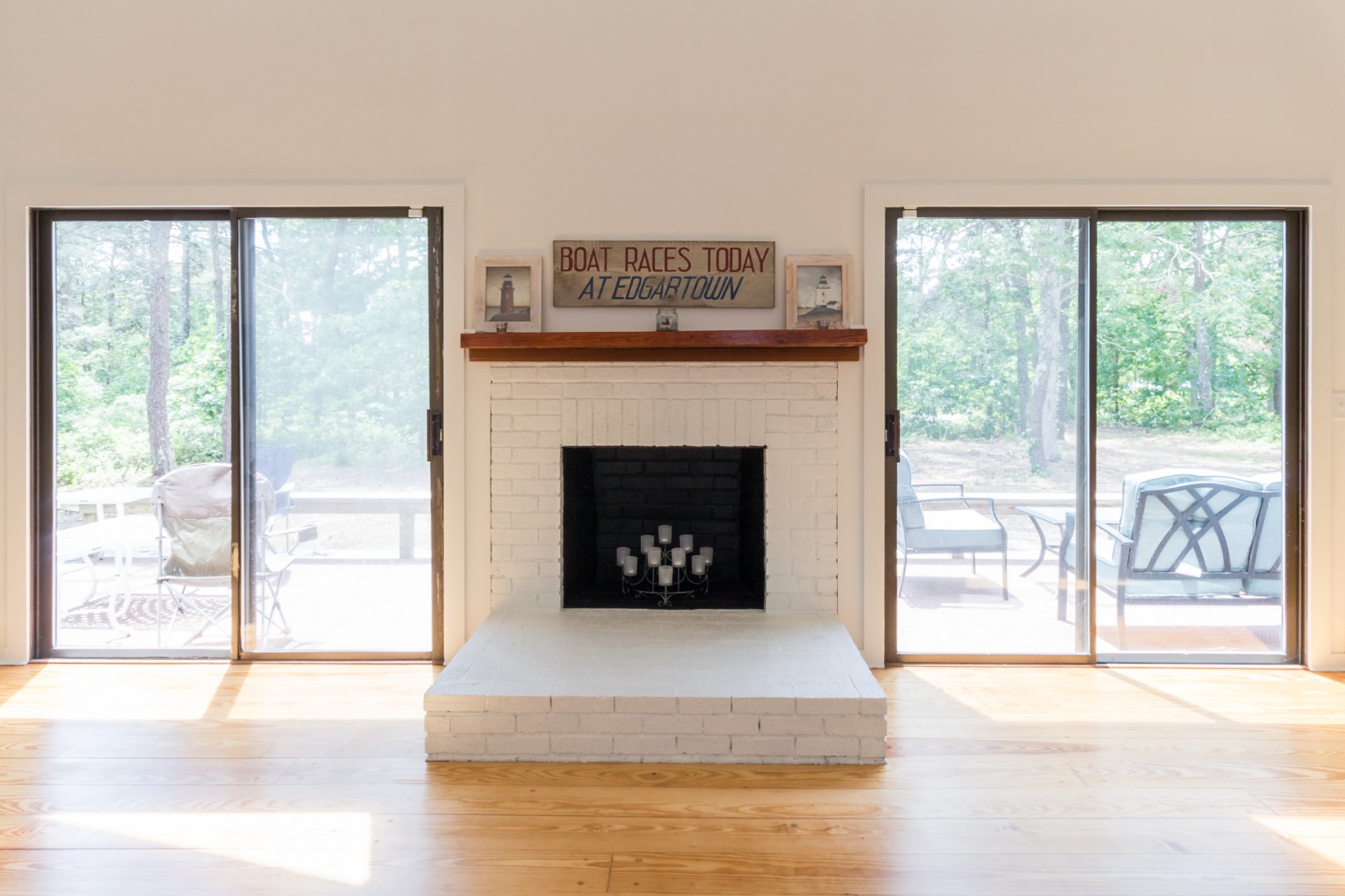 81 Marthas Road Edgartown, MA 02539 - Photo 10 of 23 a living room with a fireplace and a floor to ceiling window