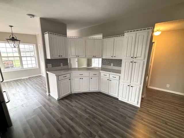 a kitchen with stainless steel appliances a refrigerator sink and cabinets