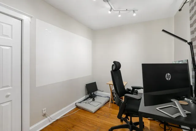 a view of a workspace with furniture and a gate
