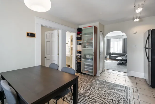 a view of a hallway to a livingroom and a livingroom with furniture