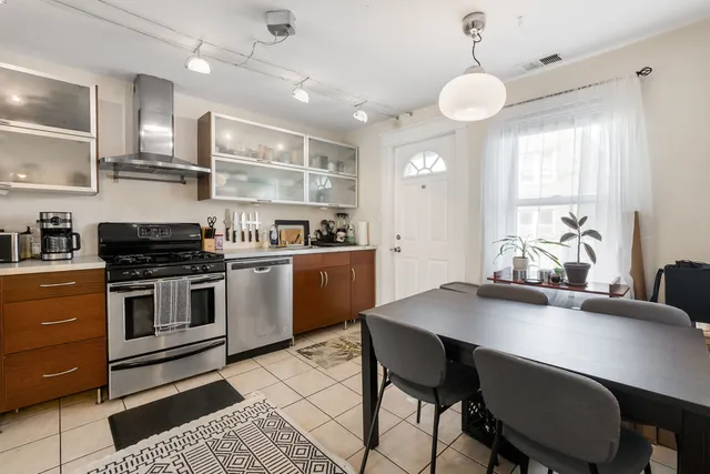 a kitchen with a table chairs stove and cabinets