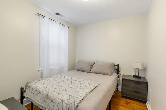 a bedroom with a bed and a mirror