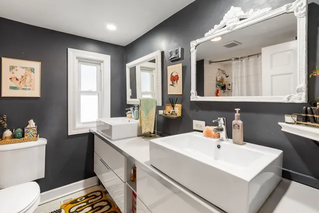 a bathroom with a sink mirror and toilet