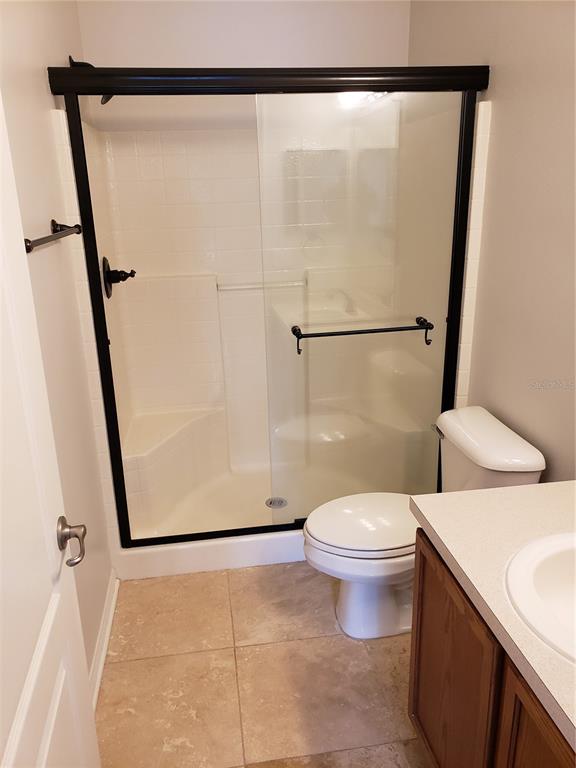 5870 Fishhawk Ridge Drive Lithia, FL 33547 - Photo 20 of 34 a bathroom with a toilet and a shower
