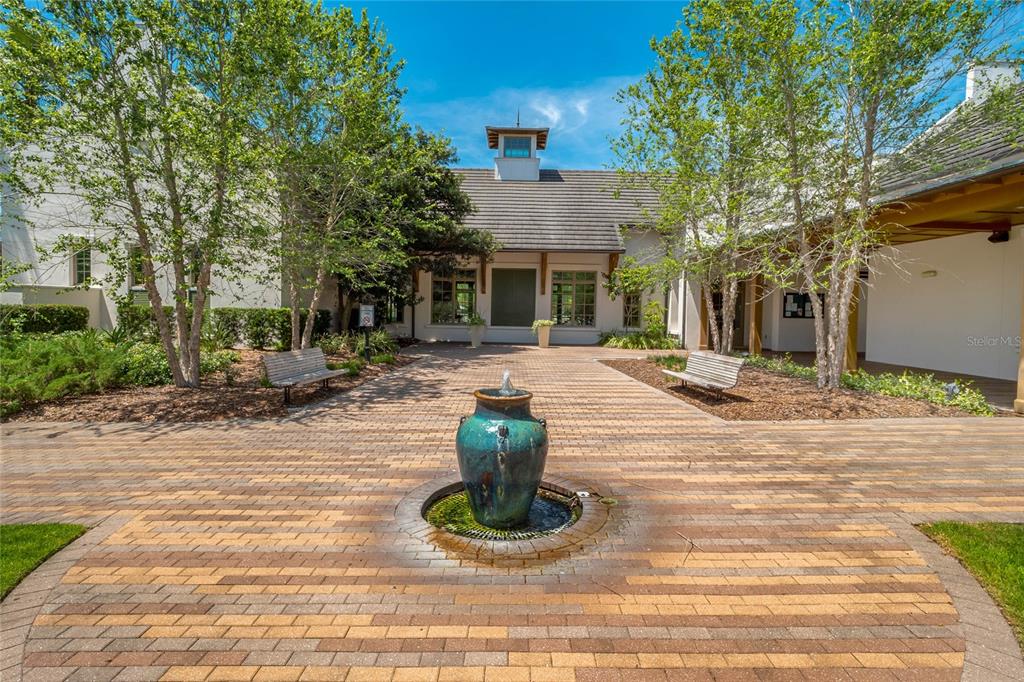 5870 Fishhawk Ridge Drive Lithia, FL 33547 - Photo 27 of 34 a view of a brick house with potted plants and a fountain