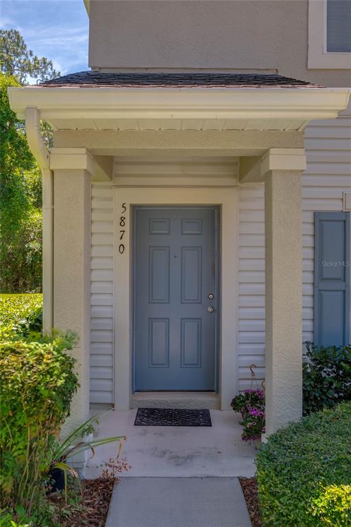 5870 Fishhawk Ridge Drive Lithia, FL 33547 - Photo 4 of 34 a front view of a house with plants