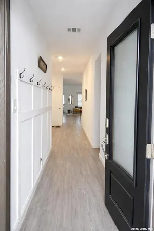 a view of a hallway view with wooden floor and furniture