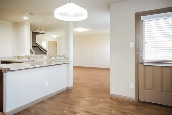 a view of kitchen with granite countertop cabinets and a sink