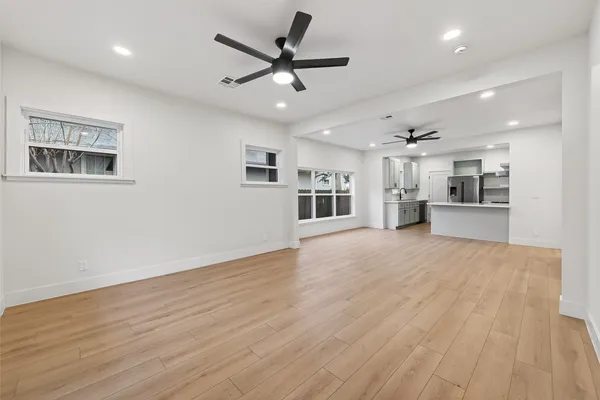 a view of a work space with wooden floor and a ceiling fan