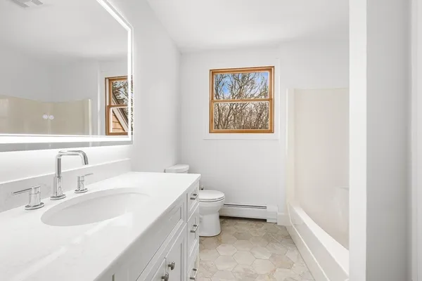 a bedroom with a bed and a potted plant