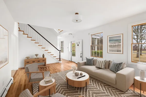 a living room with furniture and wooden floor