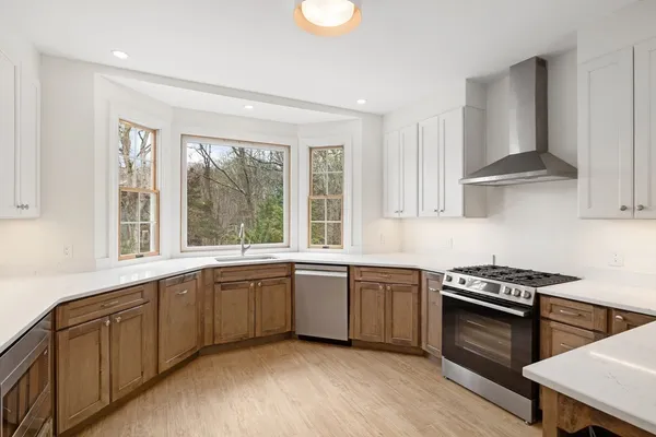 a kitchen with stainless steel appliances granite countertop sink stove and cabinets