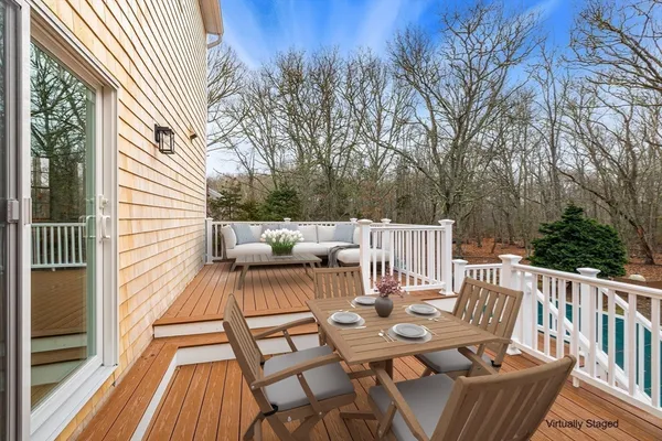 a view of balcony with wooden floor and outdoor seating