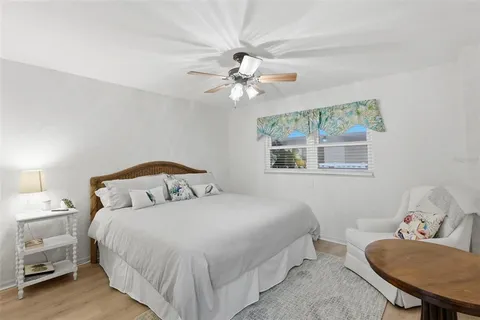 a bedroom with a bed furniture and a flat screen tv