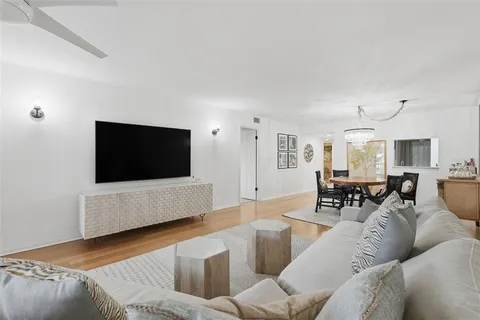 a view of a dining room with furniture wooden floor and chandelier