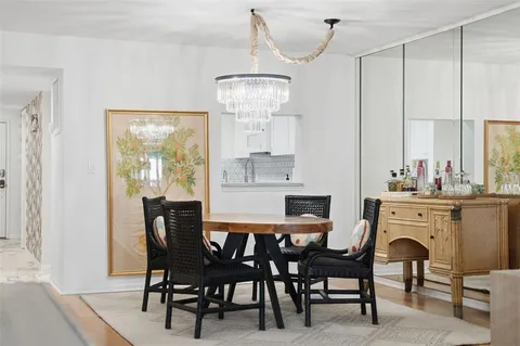 a view of a dining room with furniture and chandelier