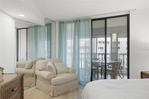 a dining room with furniture a chandelier and wooden floor