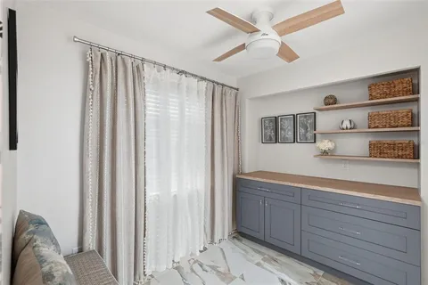 a kitchen with a refrigerator and cabinets