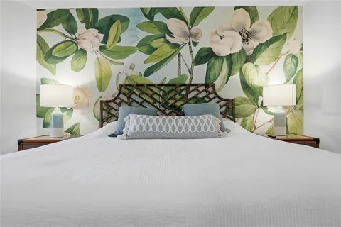 a bedroom with a bed couch and window